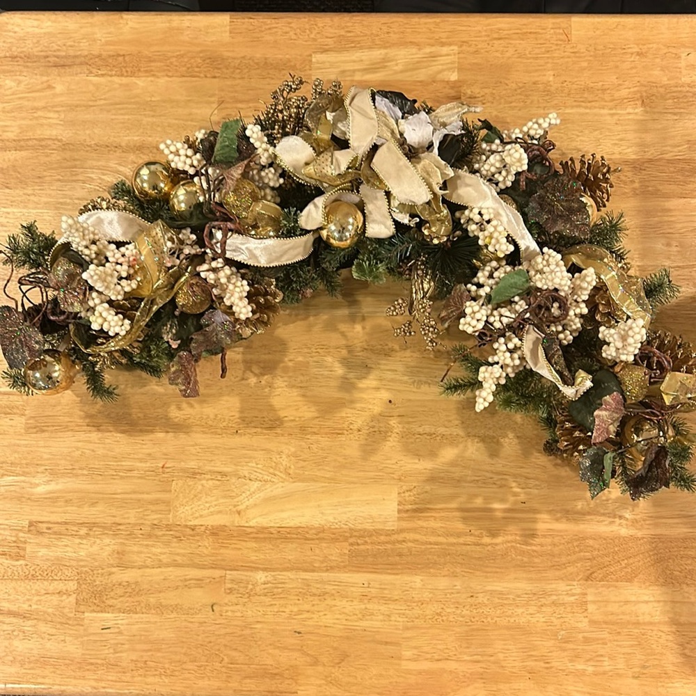 Decorative spray with gold pinecones,balls and ribbon.